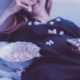 Frau isst Popcorn vor dem Fernseher
