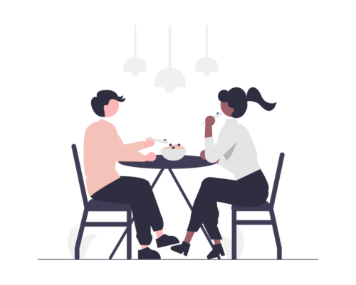 Zwei Personen sitzen am Tisch und essen gemeinsam genussvoll ein essen